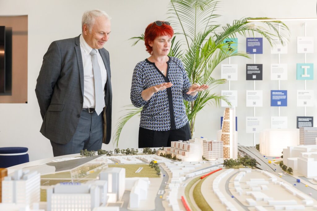 Professor Mary Ryan presents the WestTech London architecture to Frédéric Laget of Agilent Technologies.